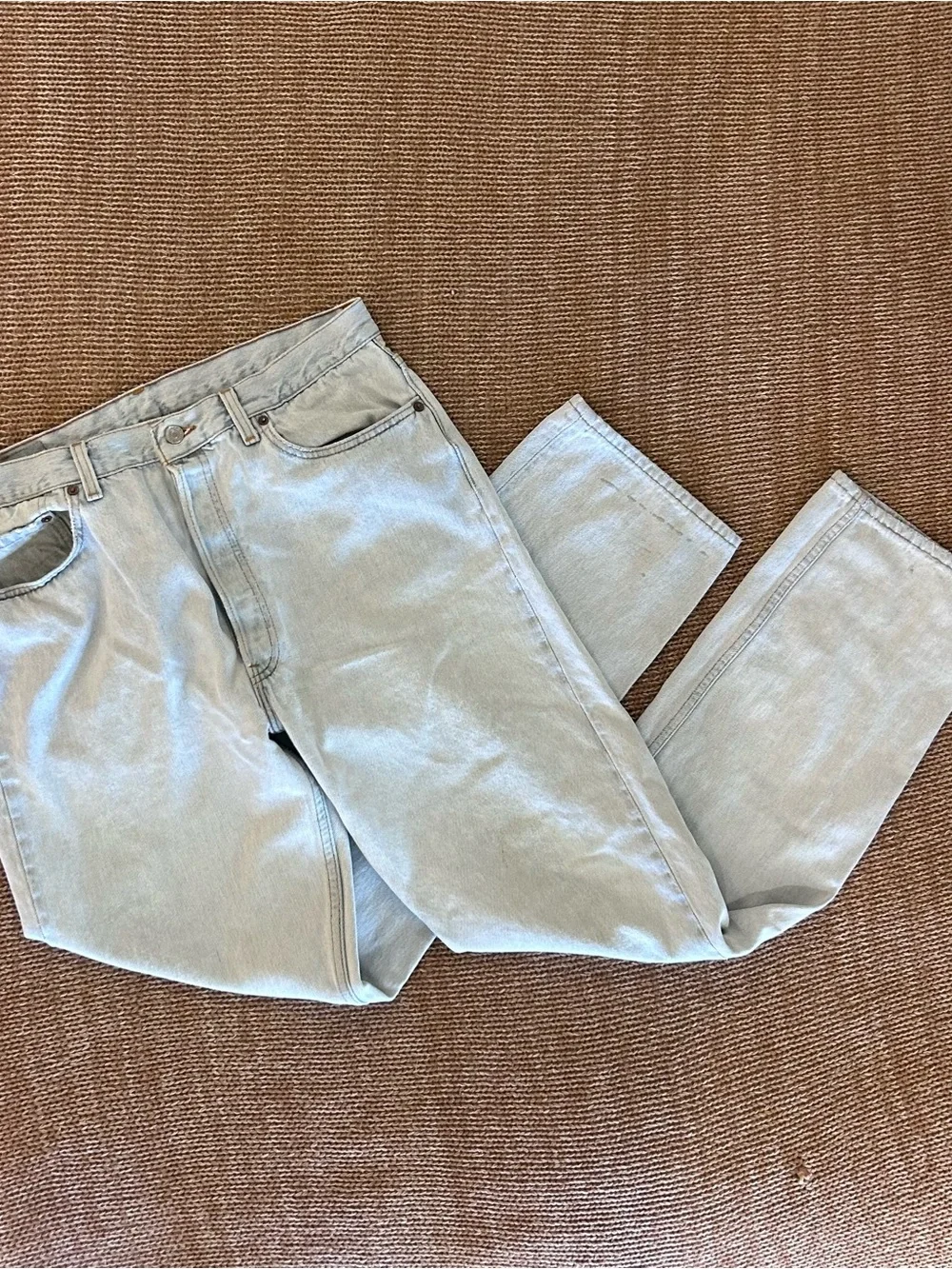 Vintage 1993 men's Levi's 501 light blue denim jeans with leather patch 38×34
